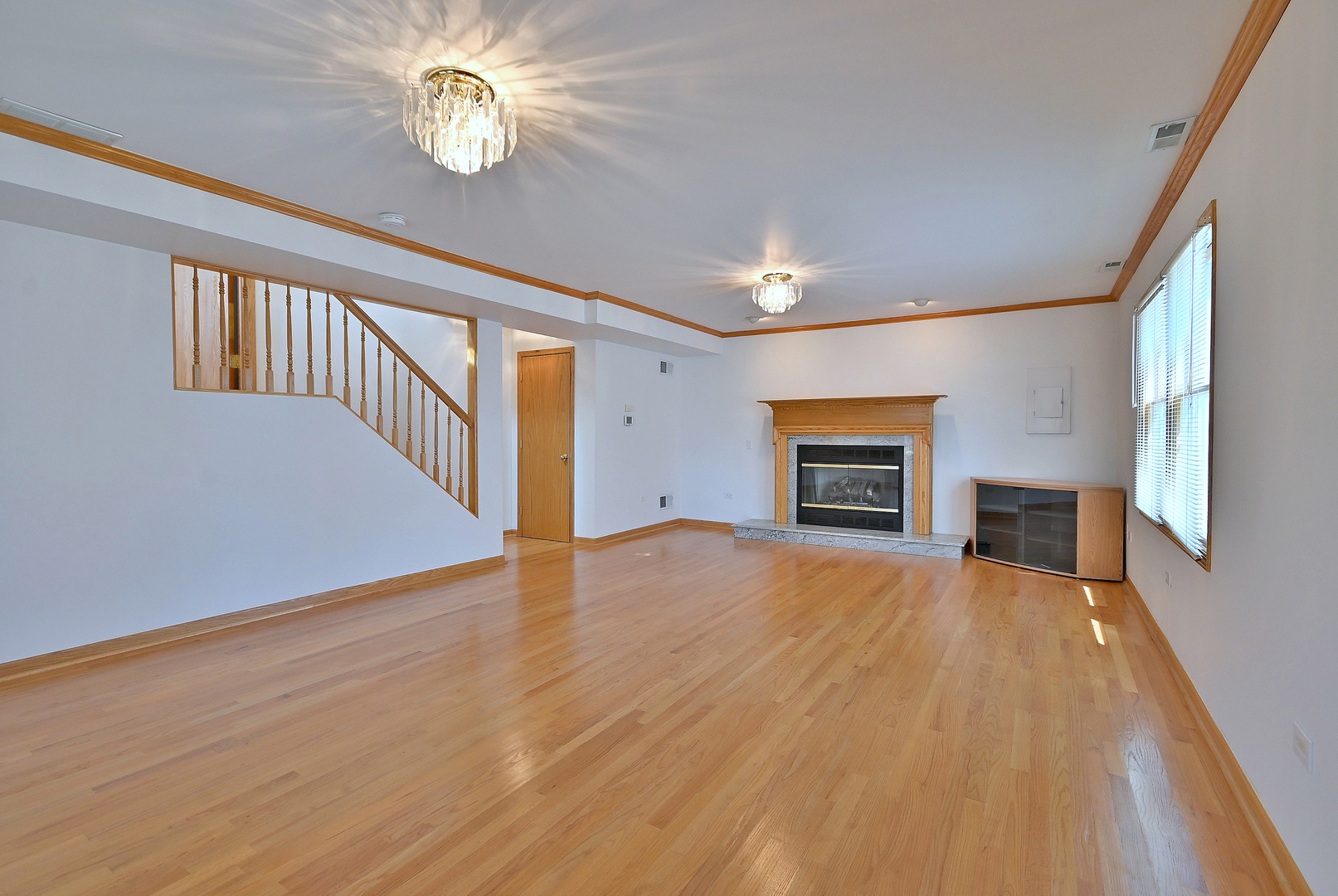 2247 Elm Street River Grove, IL 60171 - Photo 16 of 31 an empty room with wooden floor fireplace and windows