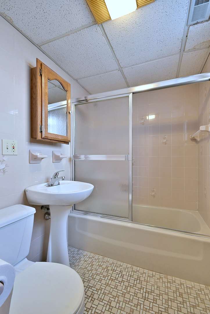 2247 Elm Street River Grove, IL 60171 - Photo 19 of 31 a bathroom with a sink toilet and shower