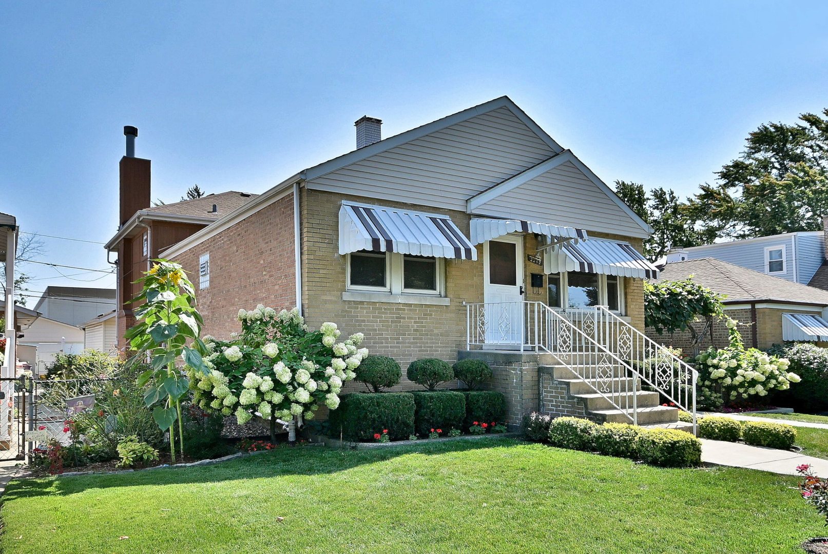 2247 Elm Street River Grove, IL 60171 - Photo 2 of 31 a front view of a house with a garden and plants
