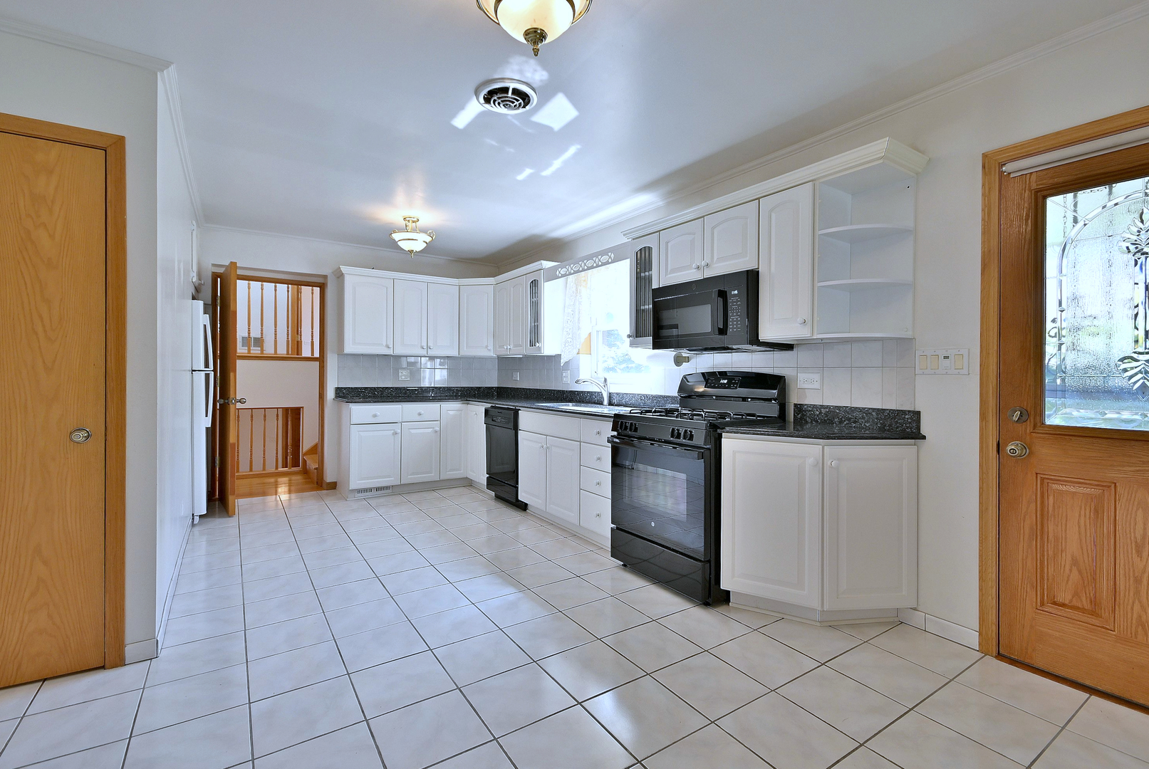 2247 Elm Street River Grove, IL 60171 - Photo 5 of 31 a kitchen with granite countertop a refrigerator and a stove top oven