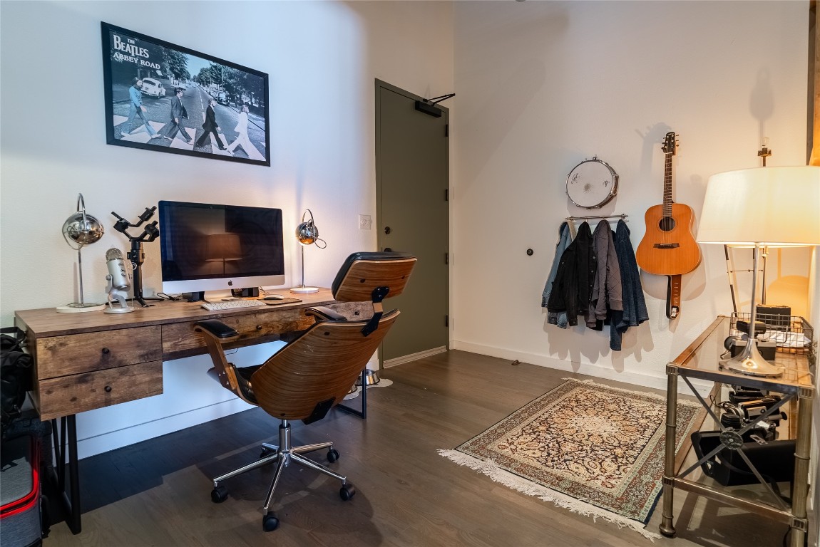 102 East 2nd Street, Unit 201 Taylor, TX 76574 - Photo 13 of 19 a view of a workspace with furniture and a flat screen tv