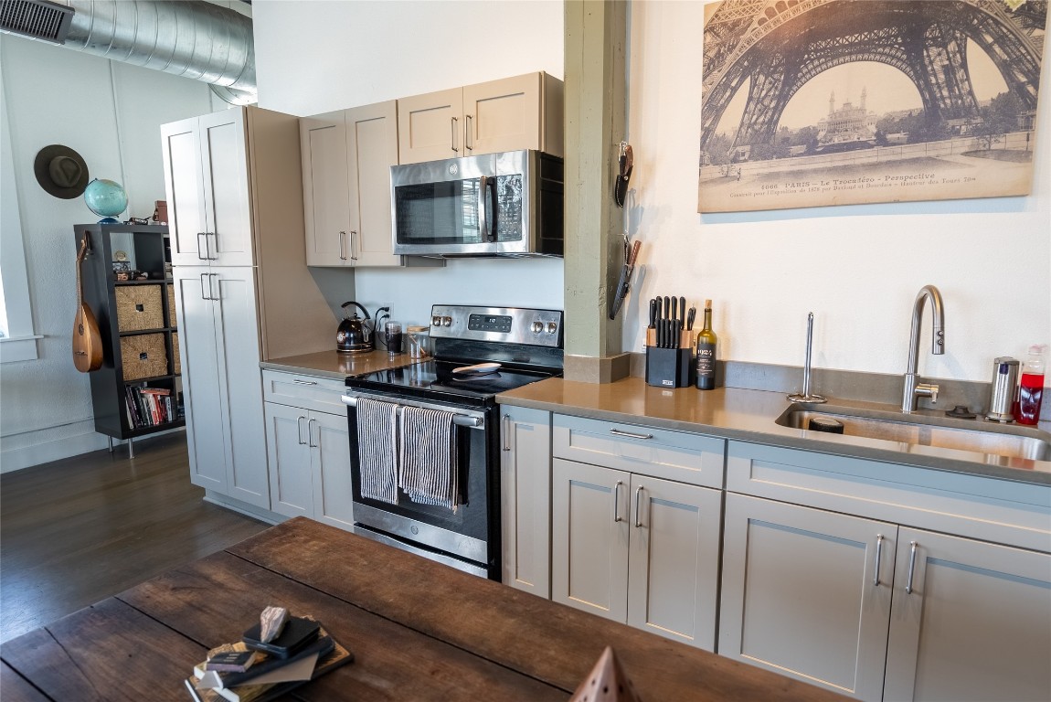 102 East 2nd Street, Unit 201 Taylor, TX 76574 - Photo 16 of 19 a kitchen with stainless steel appliances granite countertop a sink and wooden cabinets