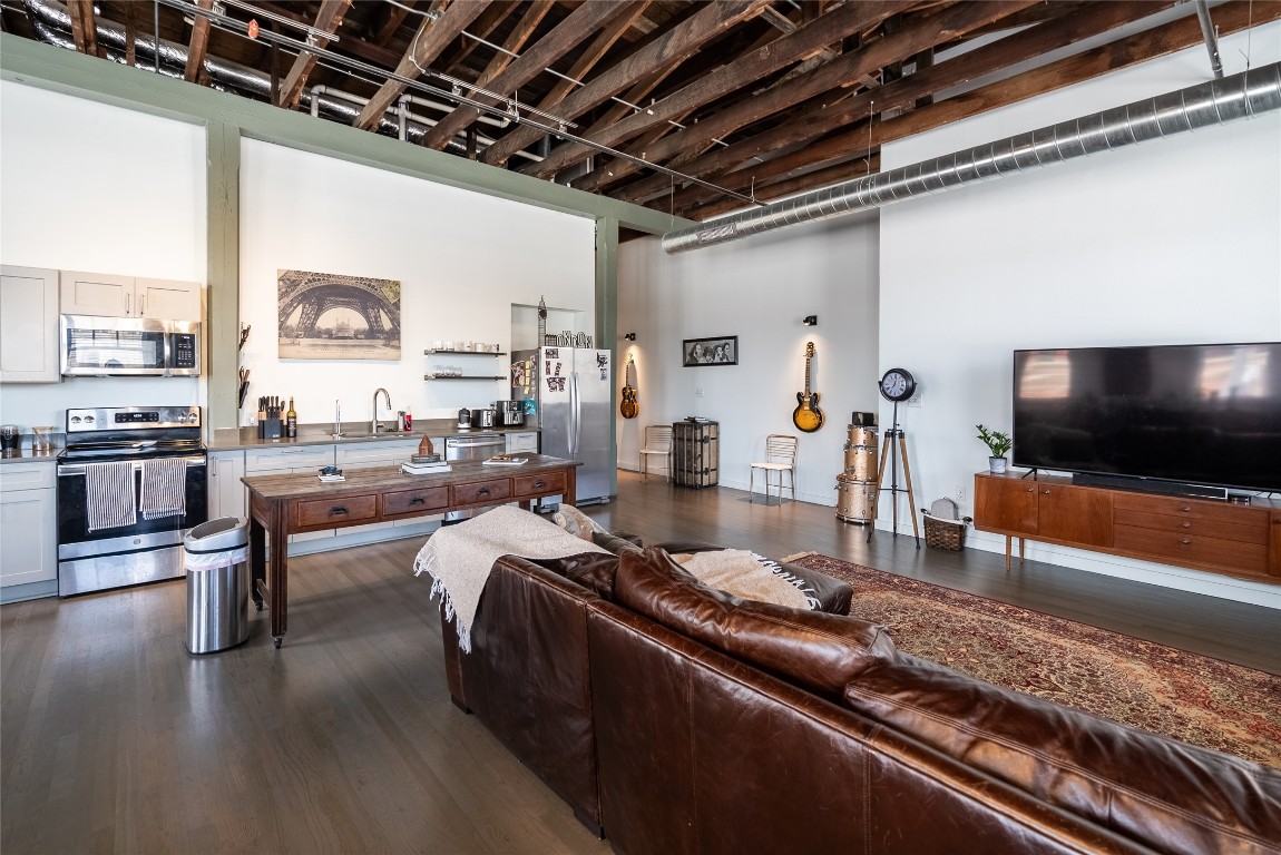102 East 2nd Street, Unit 201 Taylor, TX 76574 - Photo 5 of 19 a living room with furniture and a flat screen tv