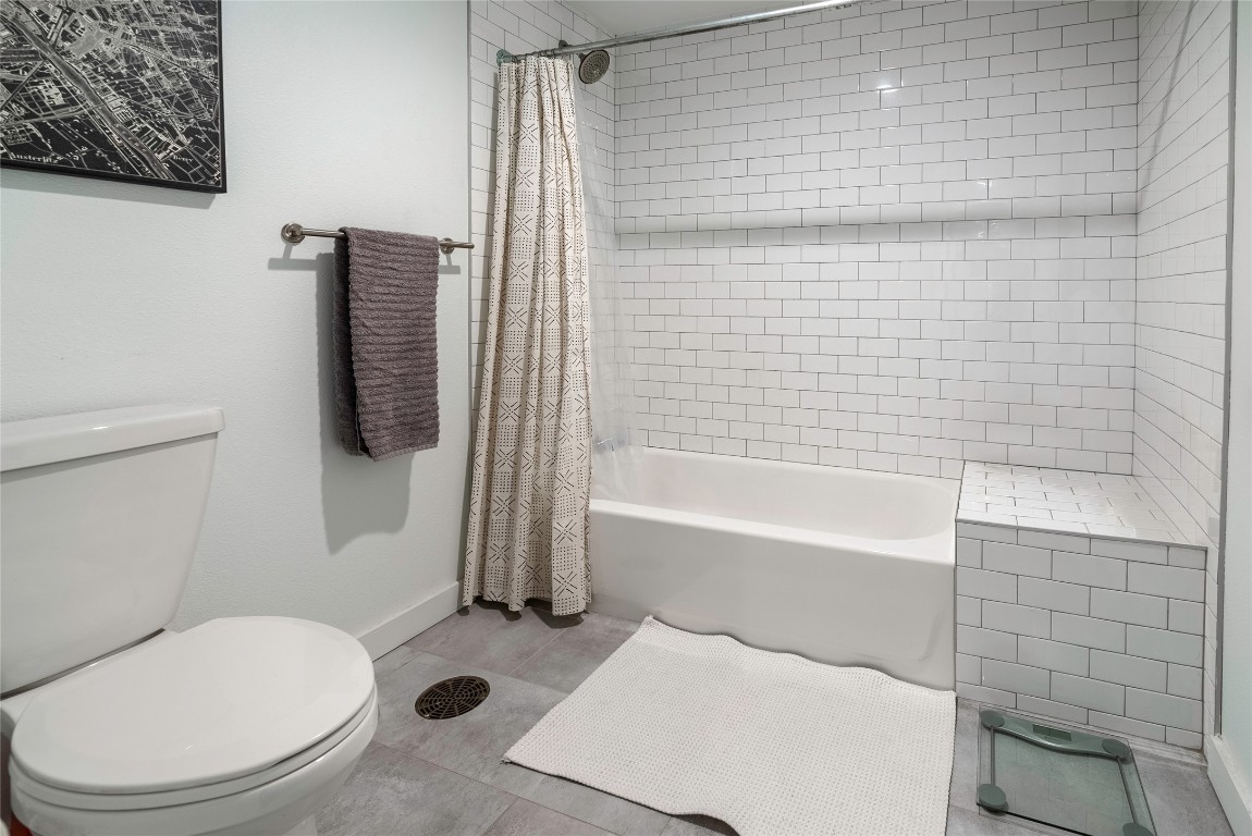 102 East 2nd Street, Unit 201 Taylor, TX 76574 - Photo 10 of 19 a bathroom with a toilet and a shower