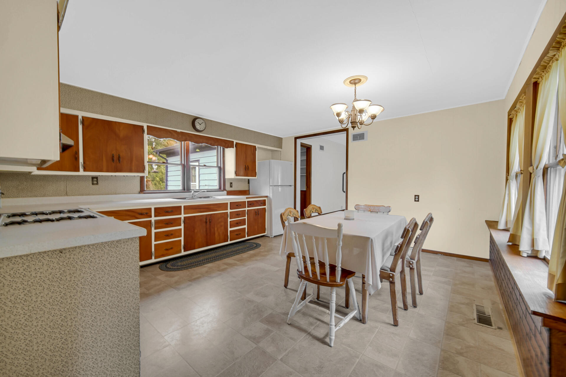 1288 North Brummitt Road Chesterton, IN 46304 - Photo 7 of 23 a dining room with a chandelier and a dining table