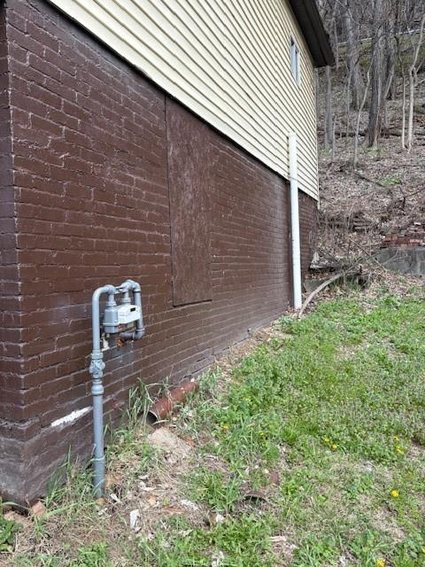1278 Lincoln Street Vandergrift, PA 15690 - Photo 22 of 22 a brick house with a yard and plants