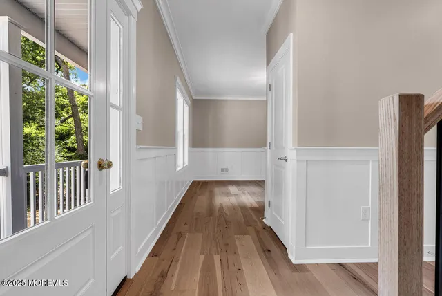 a view of a kitchen with wooden floor and a window