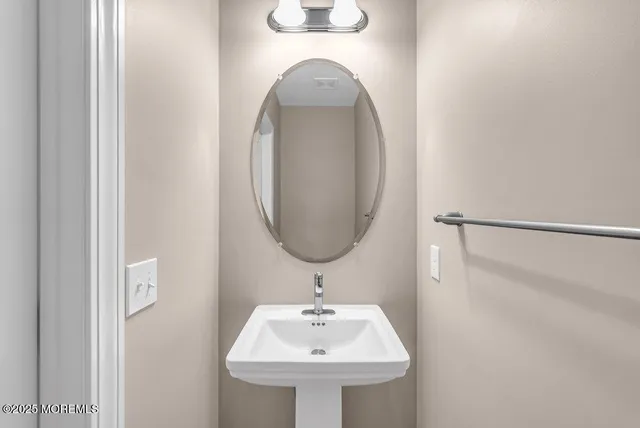 a view of a kitchen with a sink and wooden floor