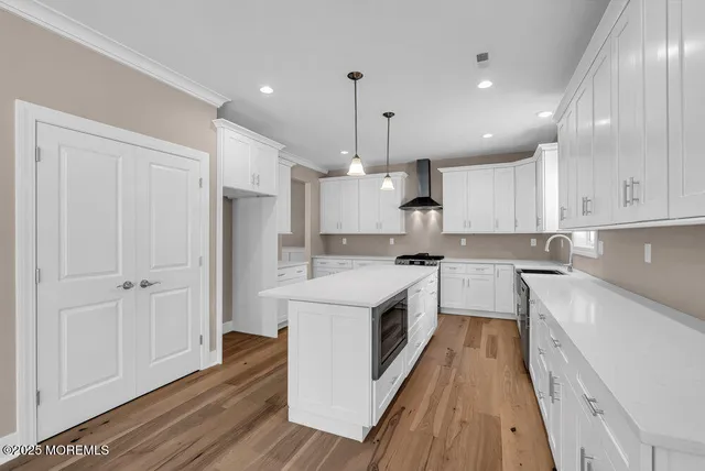 a view of hallway with wooden floor