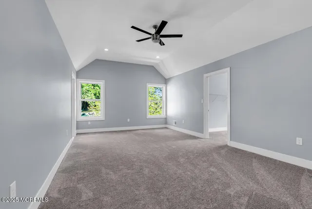 an aerial view of residential houses with outdoor space and trees all around