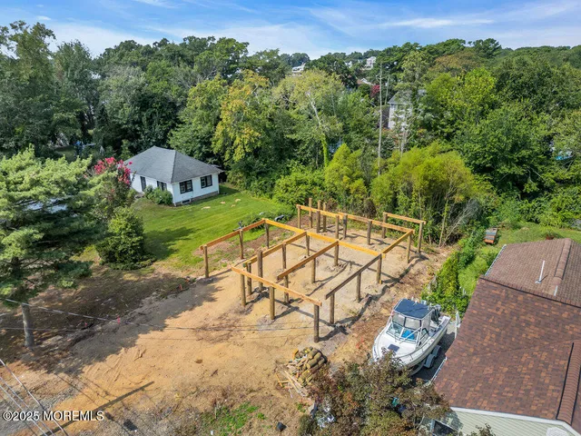 a view of empty room with wooden floor and fireplace