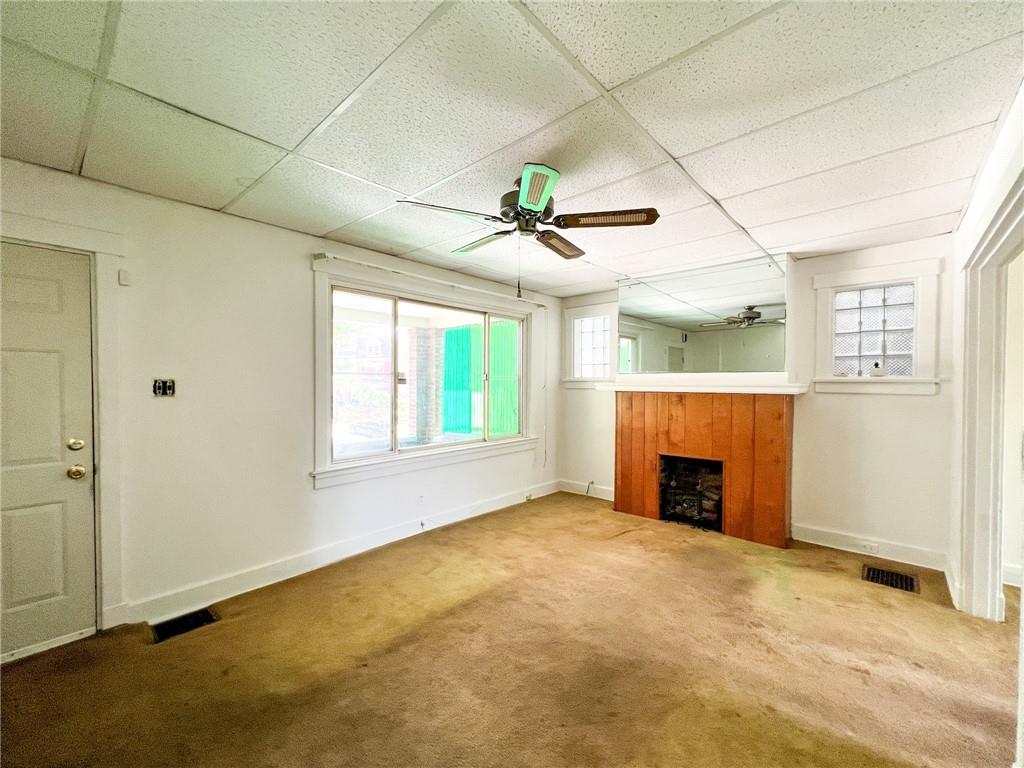 509 North Mathilda Street Pittsburgh, PA 15224 - Photo 2 of 24 a view of an empty room with a fireplace and a window