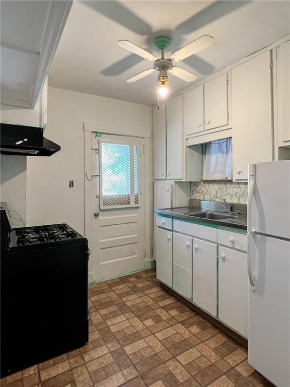 509 North Mathilda Street Pittsburgh, PA 15224 - Photo 8 of 24 a kitchen with a refrigerator and cabinets