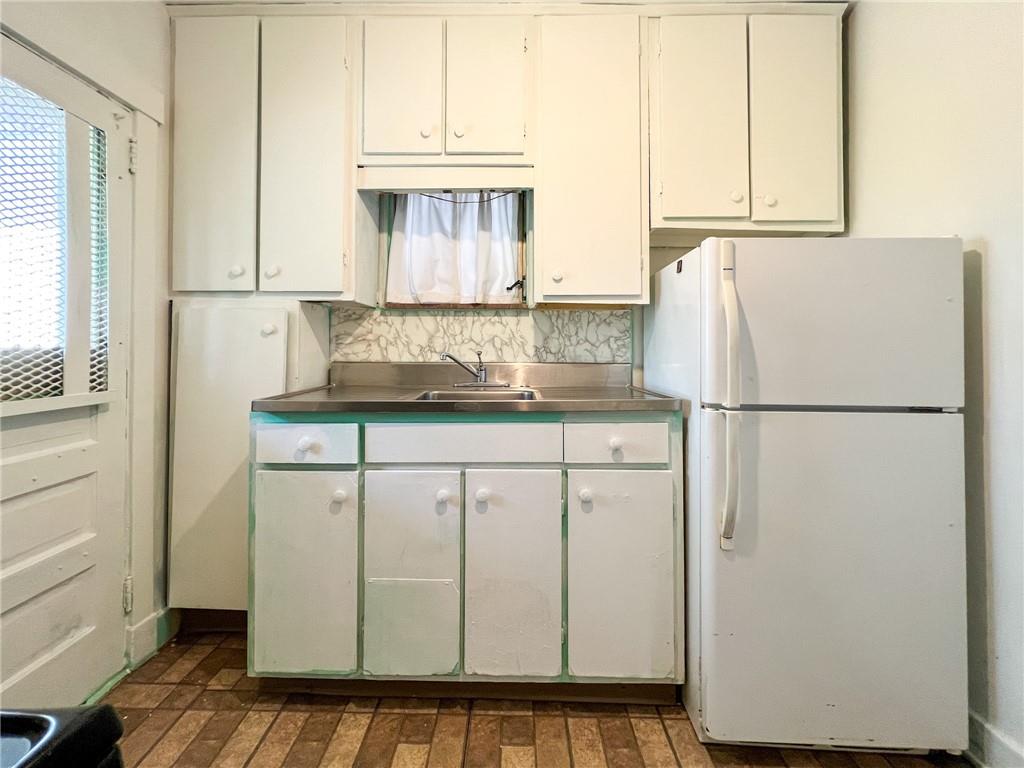 509 North Mathilda Street Pittsburgh, PA 15224 - Photo 9 of 24 a kitchen with white cabinets and refrigerator