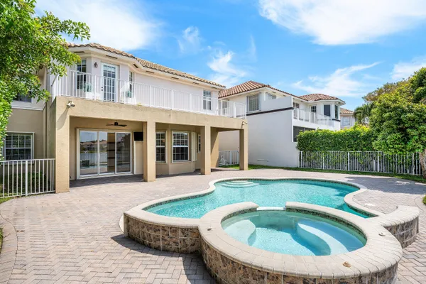 an empty room with a window and a ceiling fan