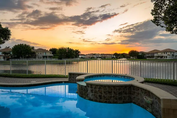 an aerial view of residential houses with outdoor space and lake view
