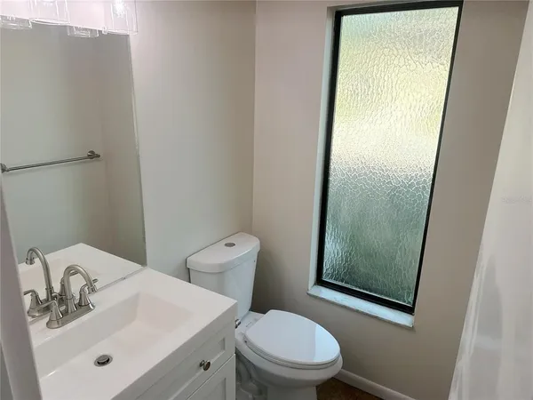 a white toilet sitting next to a bathroom sink