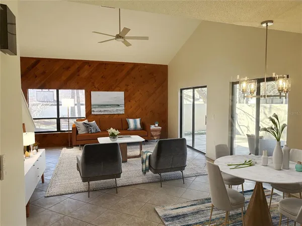 a living room with furniture a window and a chandelier
