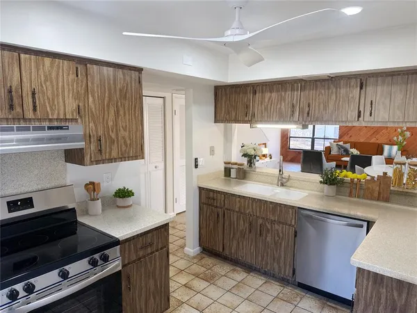 a kitchen with a sink appliances and cabinets
