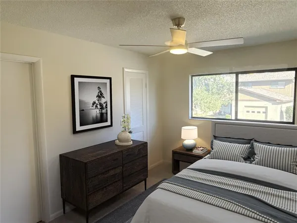 a bedroom with a bed and a window