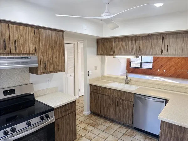 a kitchen with kitchen island granite countertop a sink and a stove