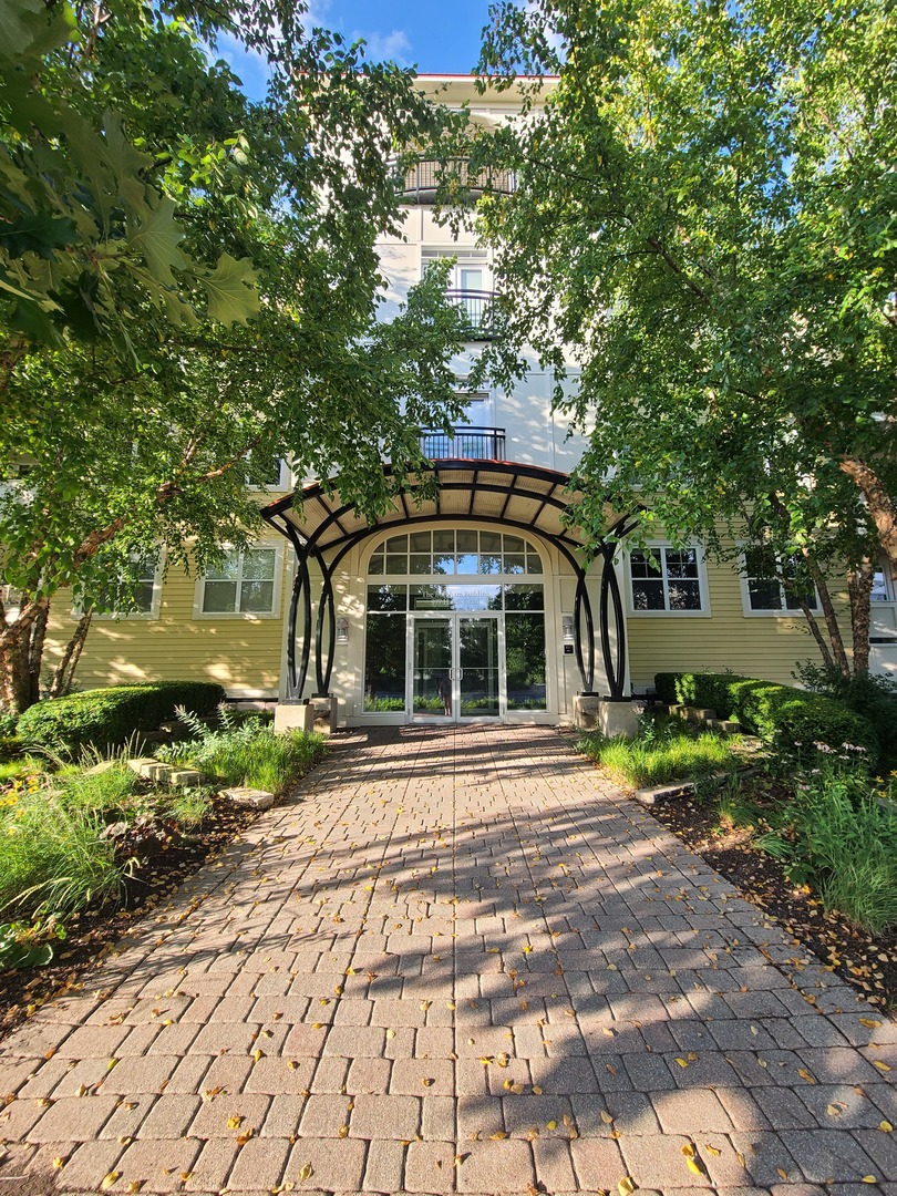 977 Harris Road, Unit 16 Grayslake, IL 60030 - Photo 2 of 41 a front view of a house with a garden