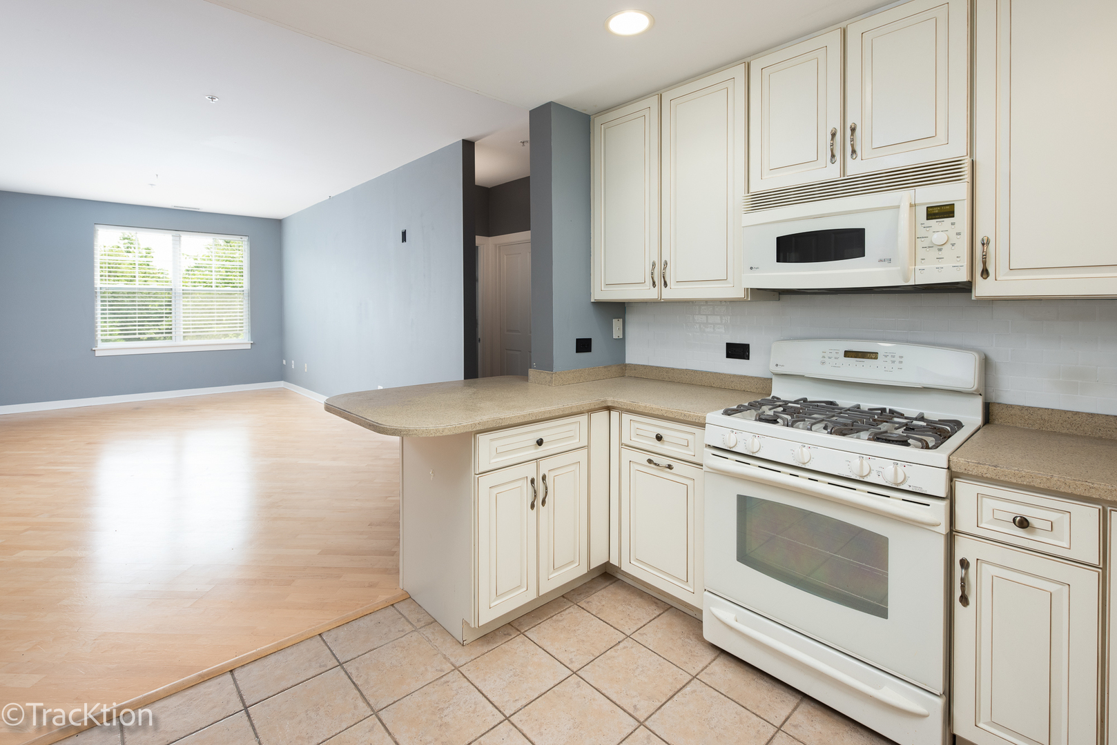 977 Harris Road, Unit 16 Grayslake, IL 60030 - Photo 10 of 41 a kitchen with granite countertop white cabinets and white appliances