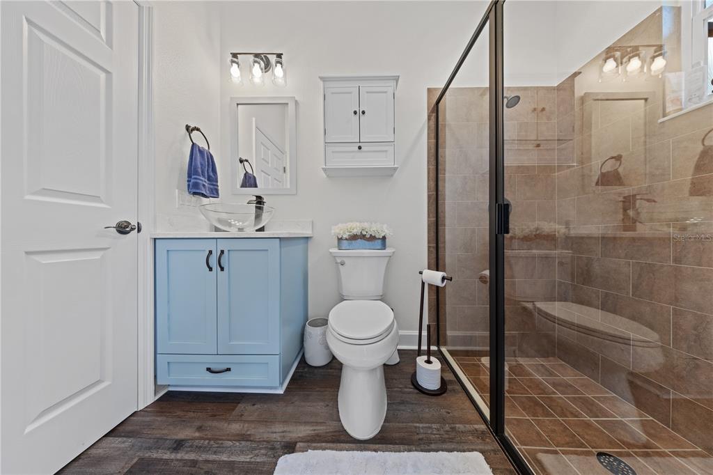 16948 Deer Island Road Tavares, FL 32778 - Photo 28 of 67 a bathroom with a toilet sink and shower