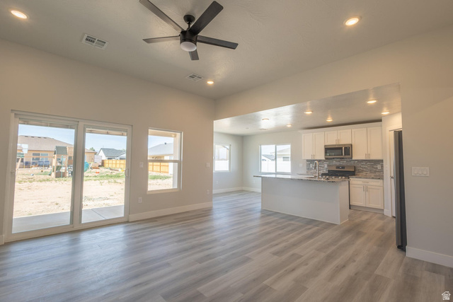 910 East Remington Road Cedar City, UT 84721 - Photo 3 of 29 Expansive interior showcasing light wood-finish flooring, recessed lighting, and a modern ceiling fan