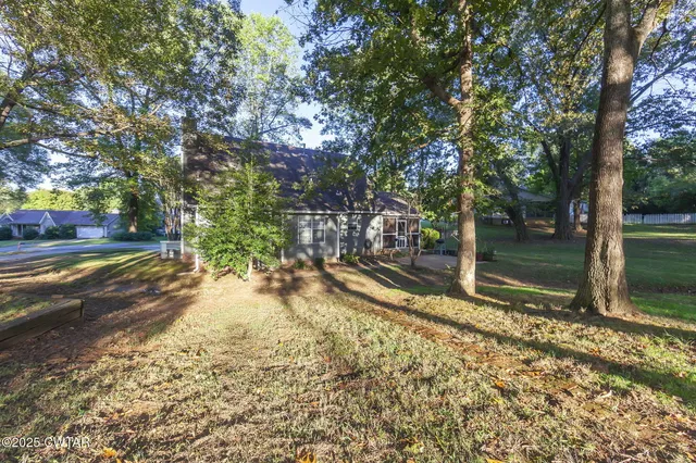 a front view of a house with a yard and a garage