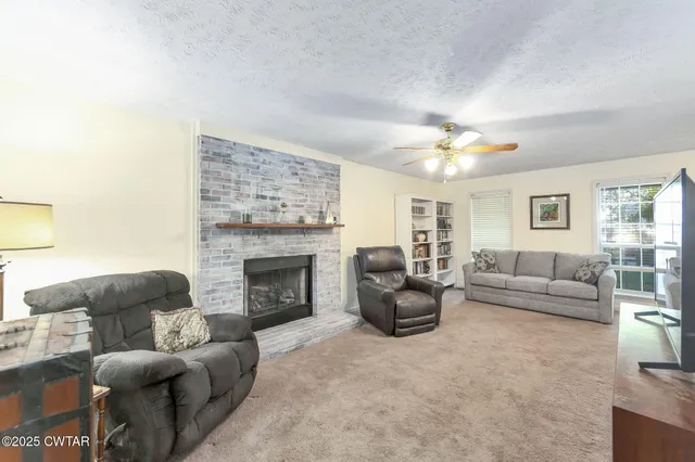 a living room with furniture and a fireplace
