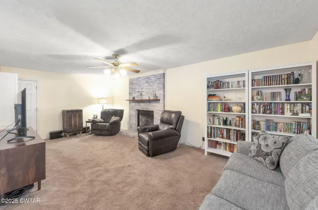 a living room with furniture and a ceiling fan
