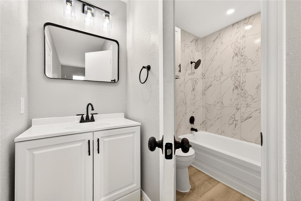 9801 Walnut Street, Unit 212 Dallas, TX 75243 - Photo 11 of 16 a bathroom with a sink a toilet and shower