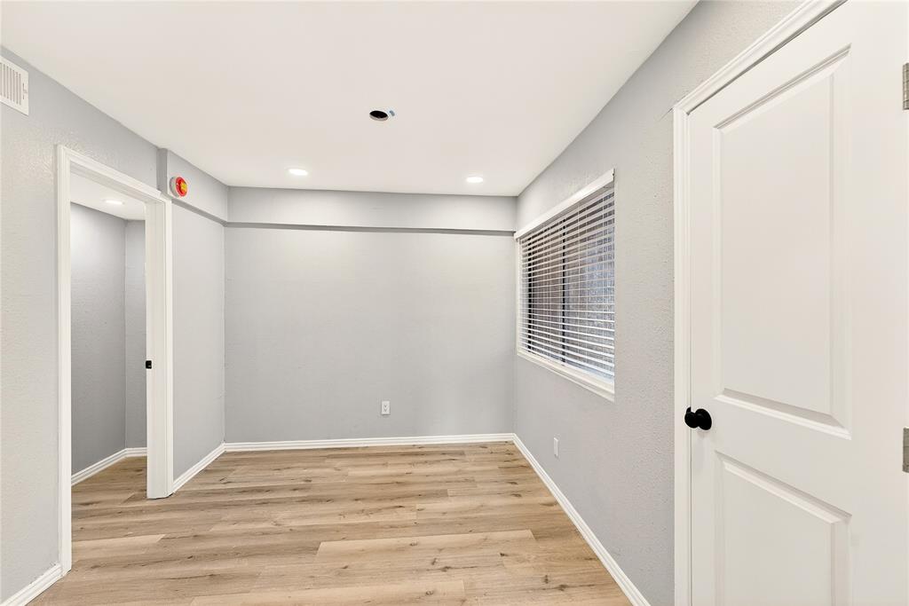 9801 Walnut Street, Unit 212 Dallas, TX 75243 - Photo 13 of 16 a view of a room with wooden floor and windows