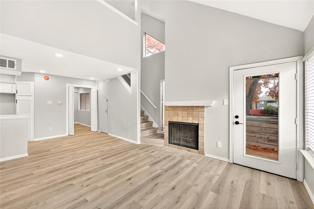 9801 Walnut Street, Unit 212 Dallas, TX 75243 - Photo 2 of 16 a bedroom with a bed and a fireplace