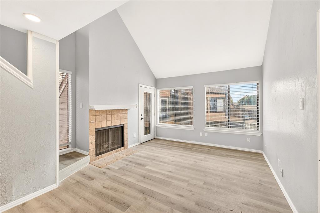 9801 Walnut Street, Unit 212 Dallas, TX 75243 - Photo 6 of 16 a view of empty room with window and fireplace