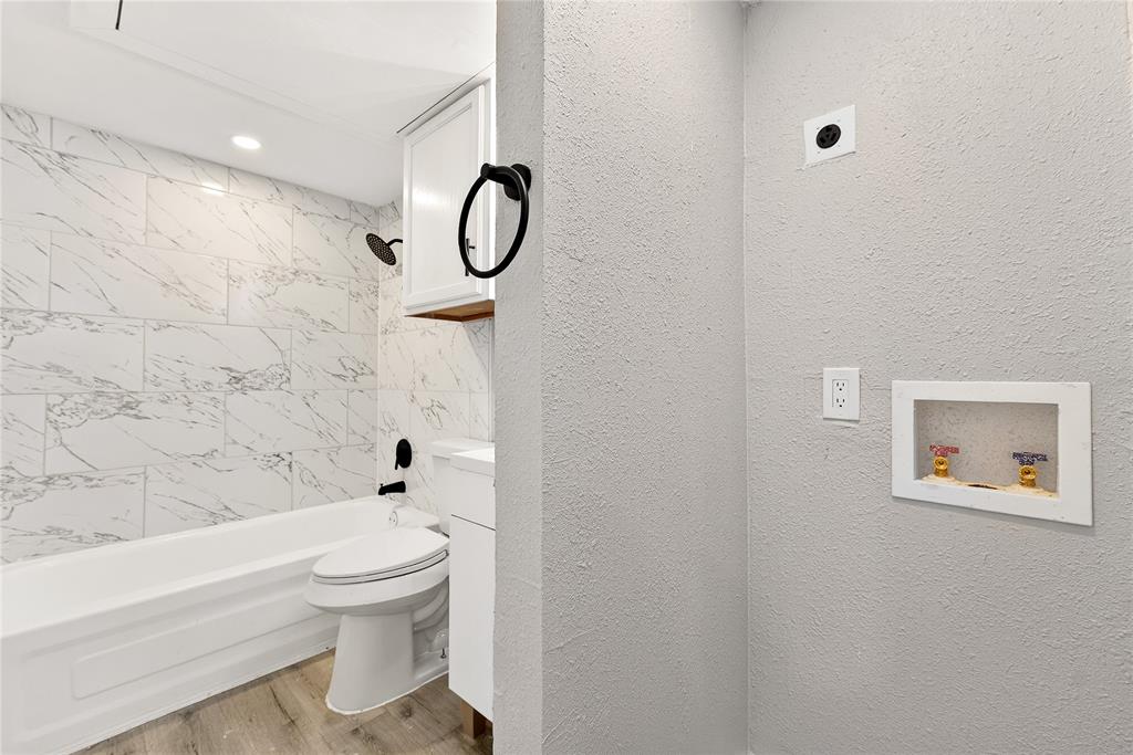 9801 Walnut Street, Unit 212 Dallas, TX 75243 - Photo 7 of 16 a bathroom with a toilet and a shower