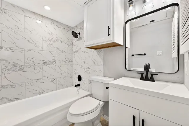 a bathroom with a sink a toilet and a bathtub