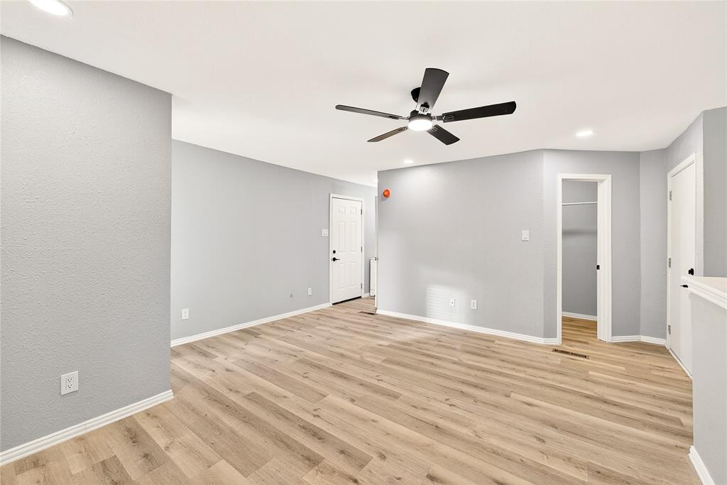 9801 Walnut Street, Unit 212 Dallas, TX 75243 - Photo 9 of 16 a view of empty room with wooden floor and fan