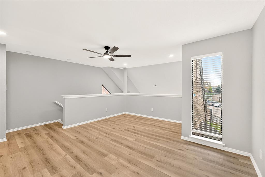 9801 Walnut Street, Unit 212 Dallas, TX 75243 - Photo 10 of 16 a view of a room with wooden floor and white walls