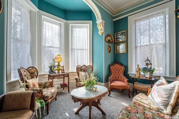 a living room with furniture and a potted plant