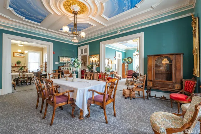 a view of a dining room with furniture and a chandelier