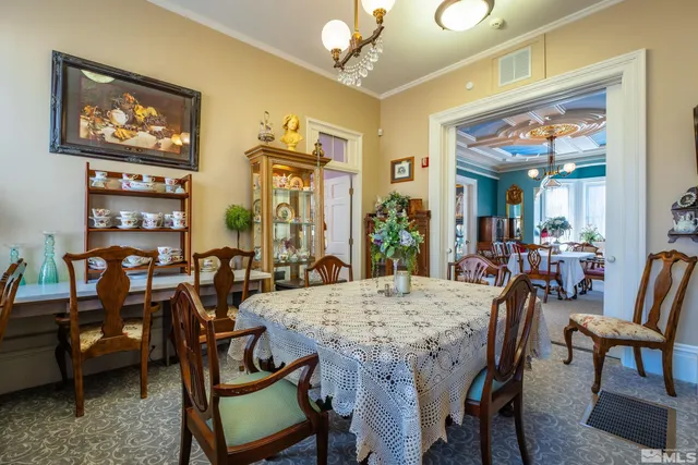 a view of a dining room with furniture and chandelier