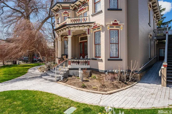 a view of a house with backyard porch and sitting area