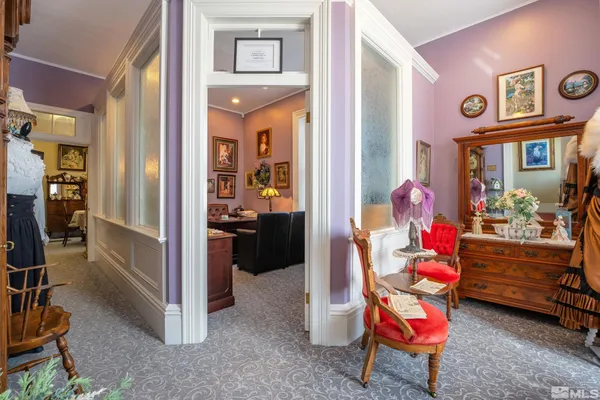 a living room with furniture and a baby crib