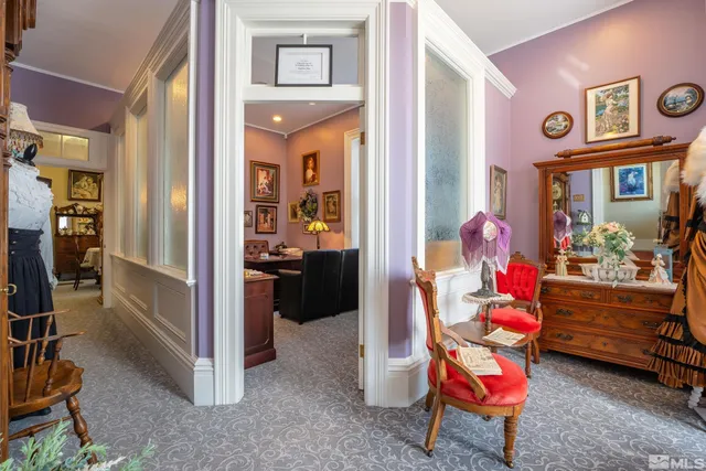 a living room with furniture and a baby crib