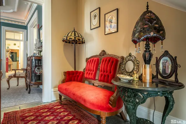 a bedroom with furniture and a mirror