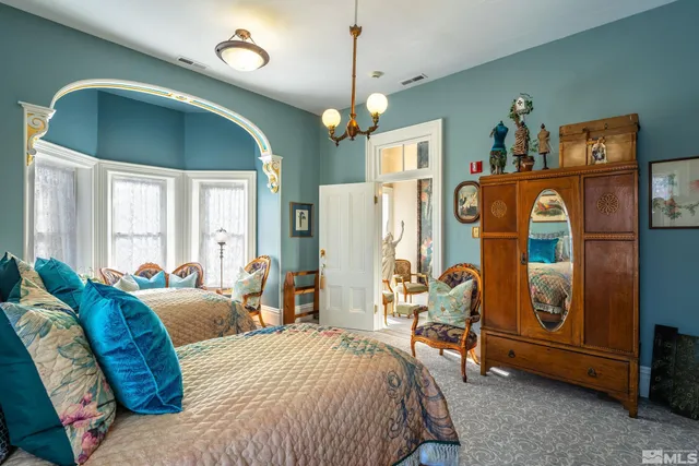 a bedroom with furniture and a chandelier