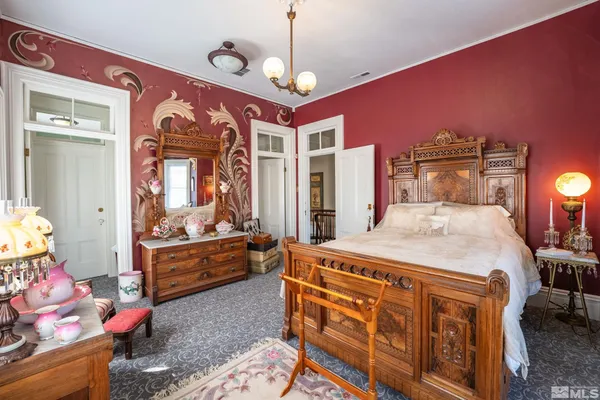 a bed room with a bed and a chandelier