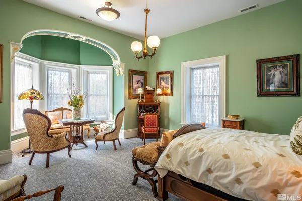 a bedroom with a bed and a chair